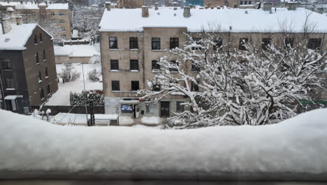 view from frozen snow window outside apartment complex in riga, latvia