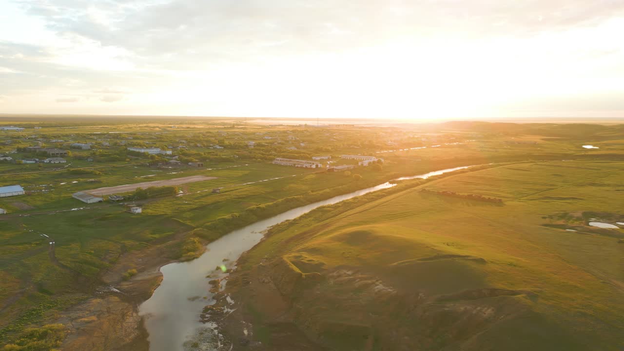 Aerial View of a River and Rural Village at Sunset