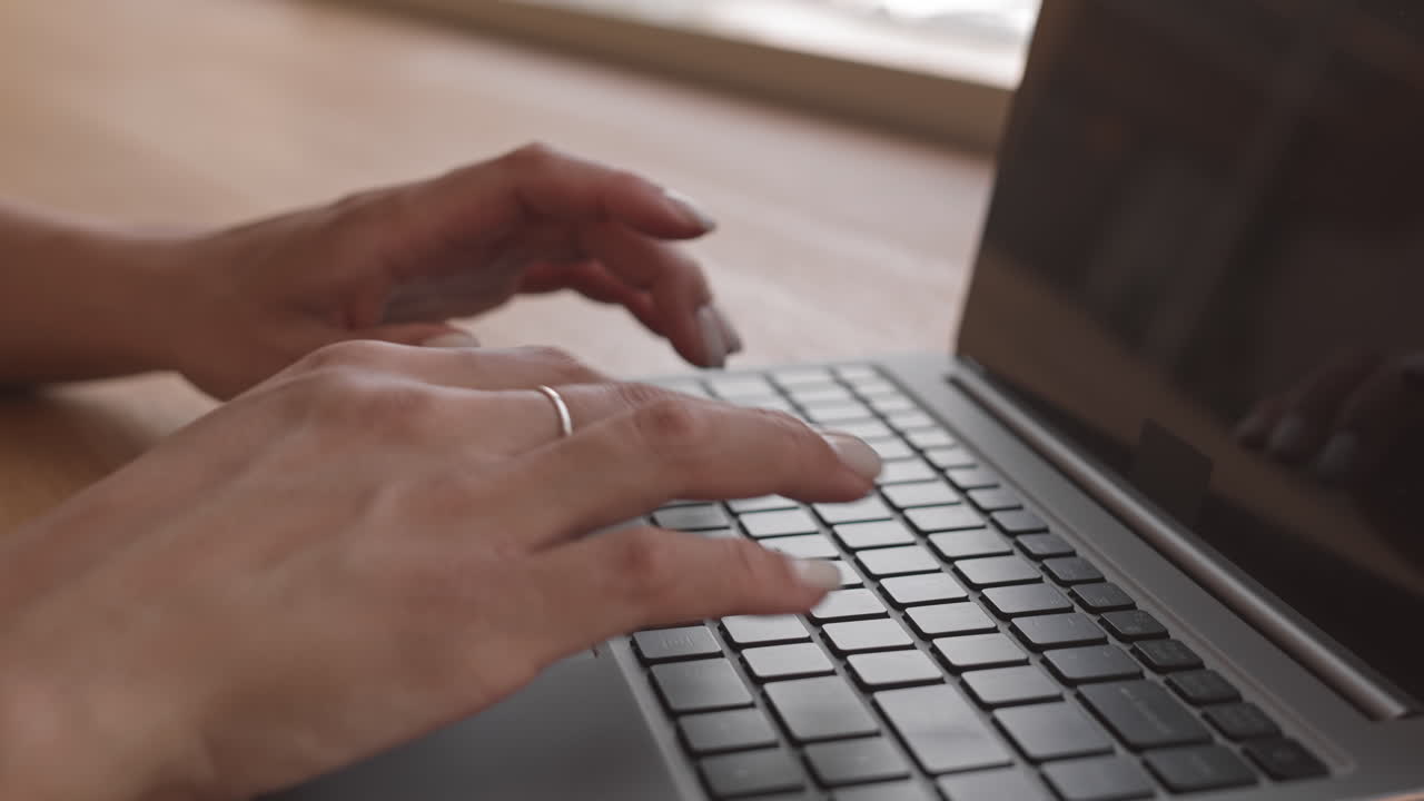 Hands Typing on Keyboard of Laptop
