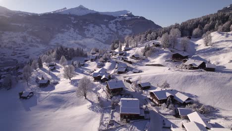 pushing in over snow covered terrassenweg in cosy mountain village grindelwald in swiss alps