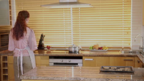 Siblings-stealing-cookies-from-the-kitchen-counter-behind-their-mothers-back