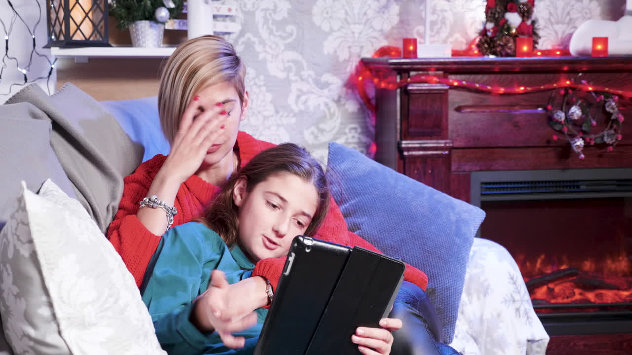 Mother and Daughter Enjoying Christmas Time with a Tablet