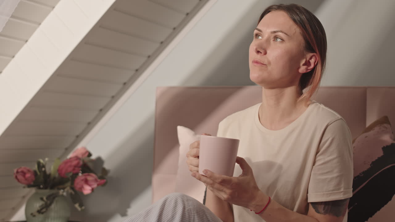 Woman Drinking Coffee in Bed