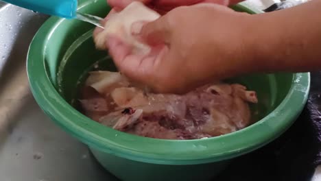 close up of washing chicken meat with water