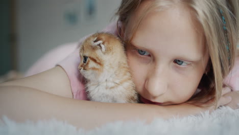 Happy-child-with-a-kitten-looking-at-the-camera