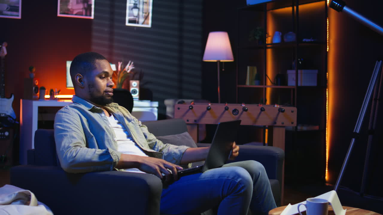 Vertical Video African american freelancer listening to podcast being focused on online work