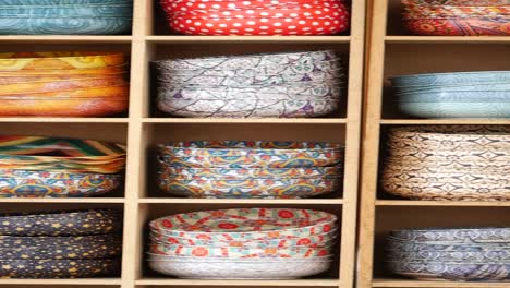 colorful decorated bowls on wooden shelves