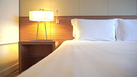 empty holiday hotel room and candid double bed with white linen