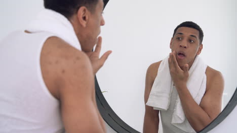 black male looking at the mirror