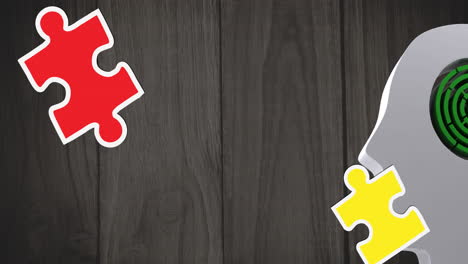 animation of green, yellow and red puzzle pieces falling over model of human head with maze