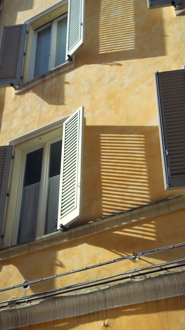 Italian Building Facade with Shutters and Shadows