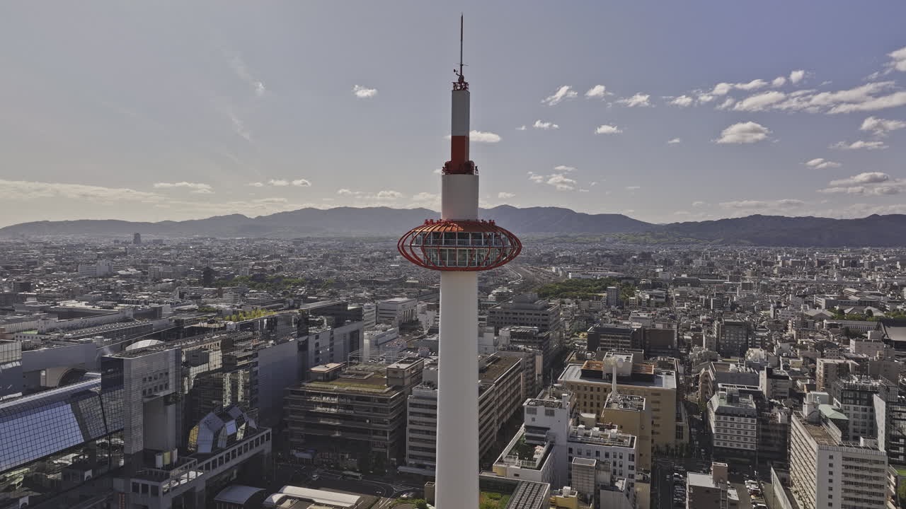 Kyoto Japan Aerial v90 reverse flyover Higashishiokojicho away from Kyoto tower capturing Shimogyo ward downtown cityscape, train station and mountain views - Shot with Mavic 3 Pro Cine - Oct 8th 2023