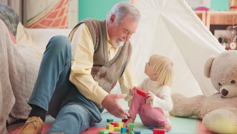 toys, bonding and grandfather playing with a child