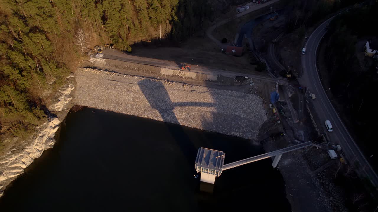 Excavator standing on the construction of the Křetínka dam near Letovice in the Czech Republic - aerial view