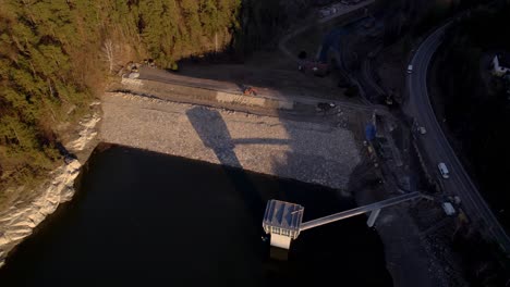 excavator standing on the construction of the křetínka dam near letovice in the czech republic - aerial view