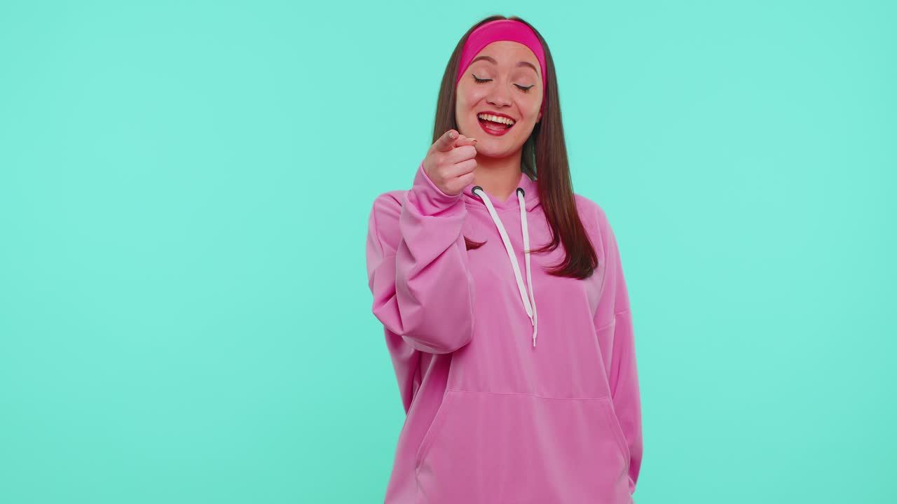 Girl smiling excitedly pointing to camera beauty choosing lucky winner indicating to awesome you