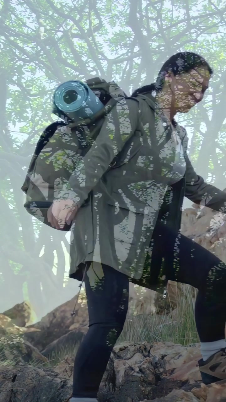 Vertical video: Stepping down hiker in boots going on rocky slope to hike with olive pack, blue mat