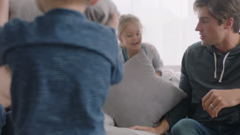 happy family having pillow fight mother and father enjoying playing with children at home having fun together on weekend 4k footage