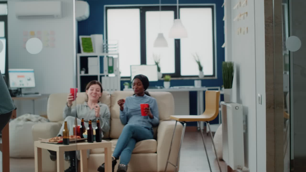 Cheerful people having fun with chair at office after work