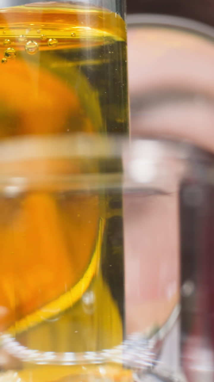 Female medical researcher looks through magnifying glass at samples in test tubes in lab slow motion. Probe lens shot of liquids diffusion macro