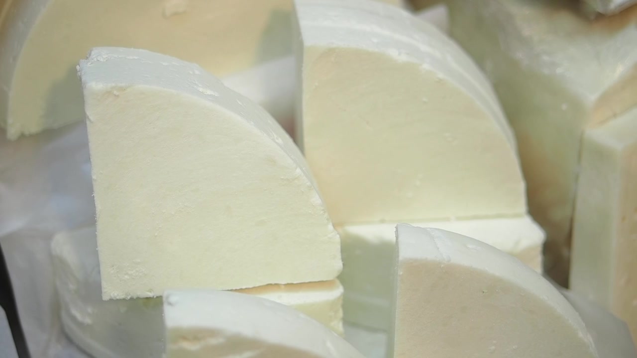 Close-up of Fresh White Cheese Wedges and Blocks