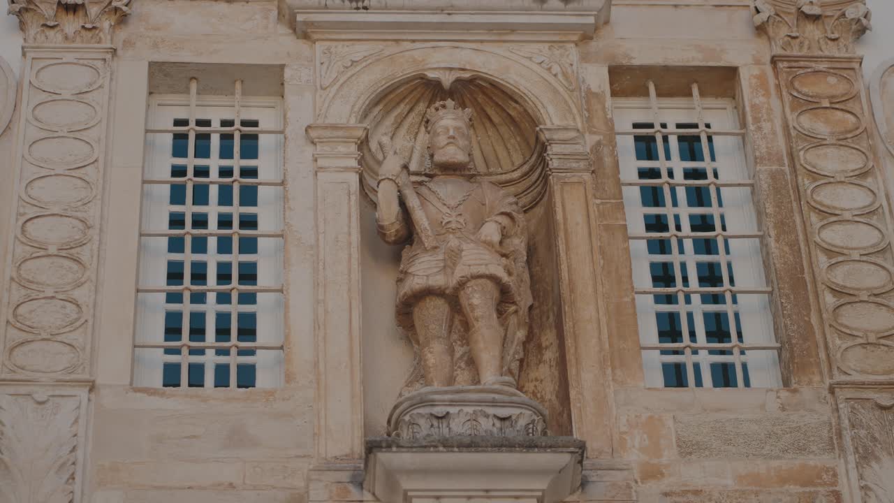 Stone Statue of a King on a Building Facade