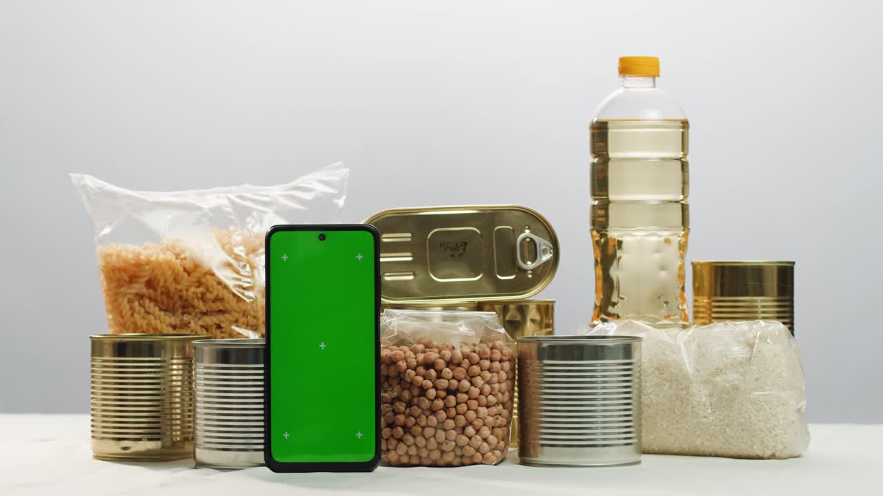 Canned cereals beans fish and vegetables, an assortment of processed foods, supermarket cart online shopping, delivery.