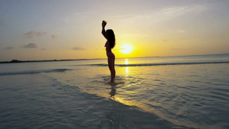 barefoot ethnic girl carefree dancing on tropical beach