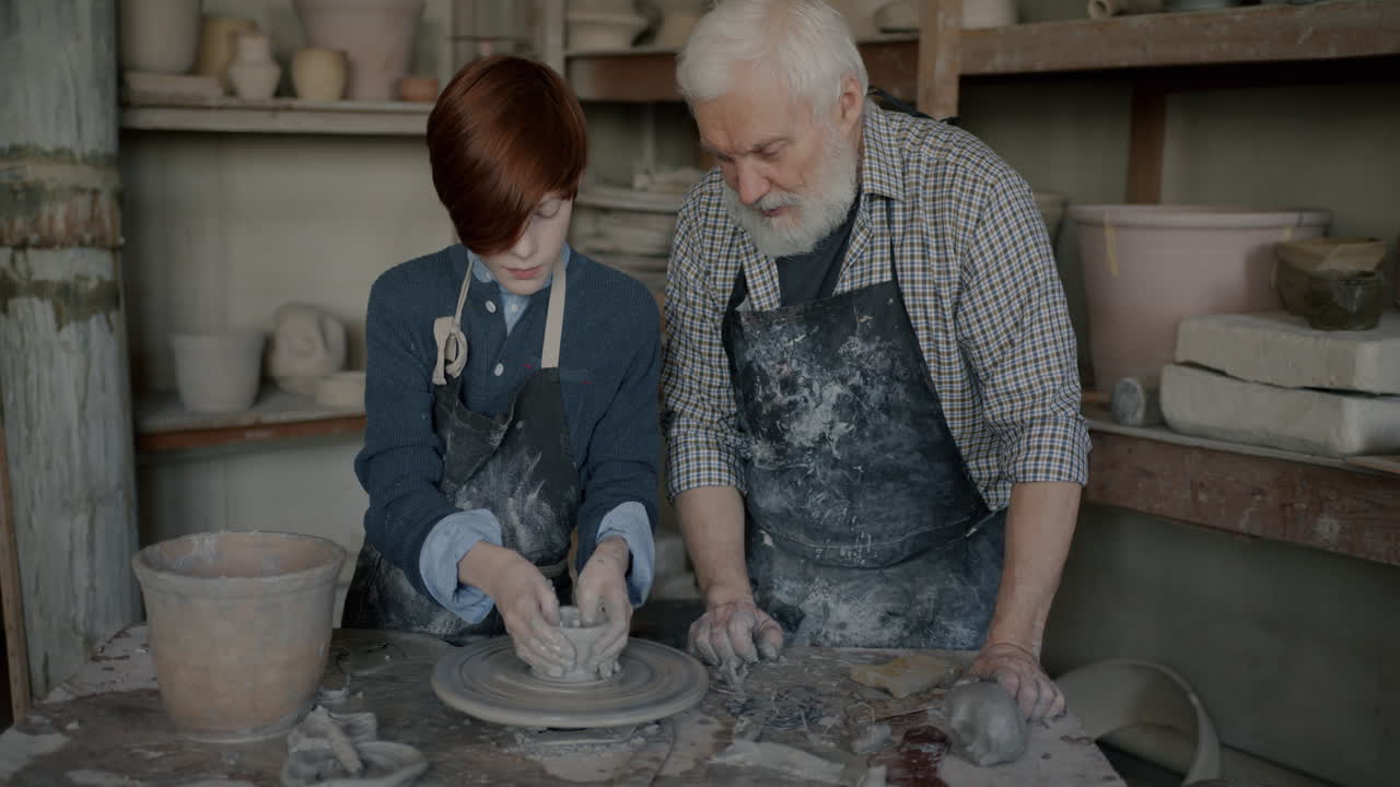 Grandfather and Grandson Learning Pottery