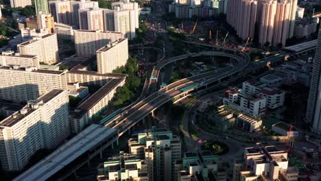 Drone-Aerial-Top-View-of-Building-with-Bridge-inside-crossing-commercial-and-residential-downtown,-Mong-Kok-Kowloon-of-Hong-Kong-City-Skyline