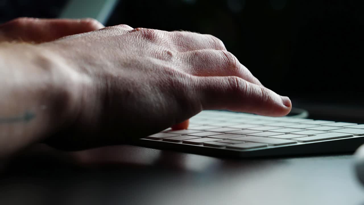 Detail-Oriented Individual Engaged in Typing on a Sleek Keyboard, Embodying the Art of Digital Content Creation