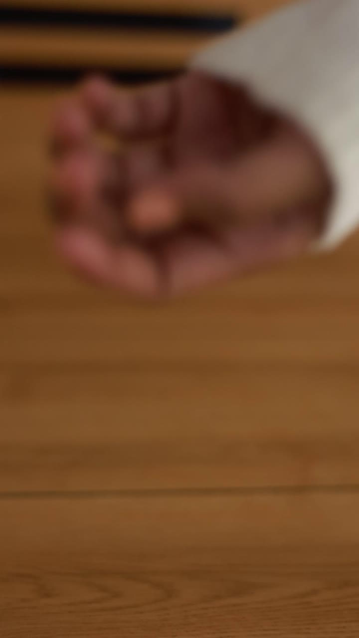 close up of a hand in wooden floor
