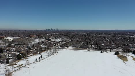 a drone shot over a park outside of denver after a spring snowstorm