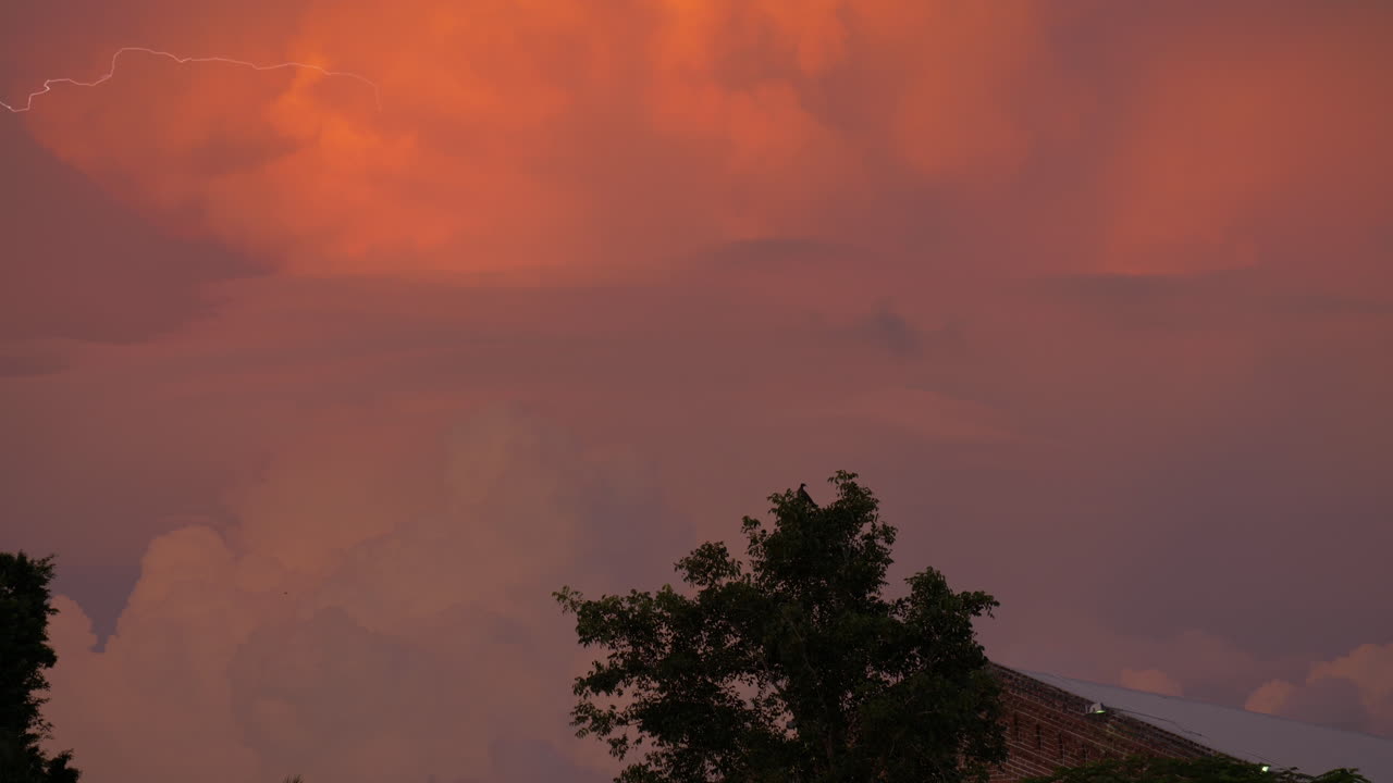 Lightening strike filmed in an orange and purple cloud during sunset in Key West FL