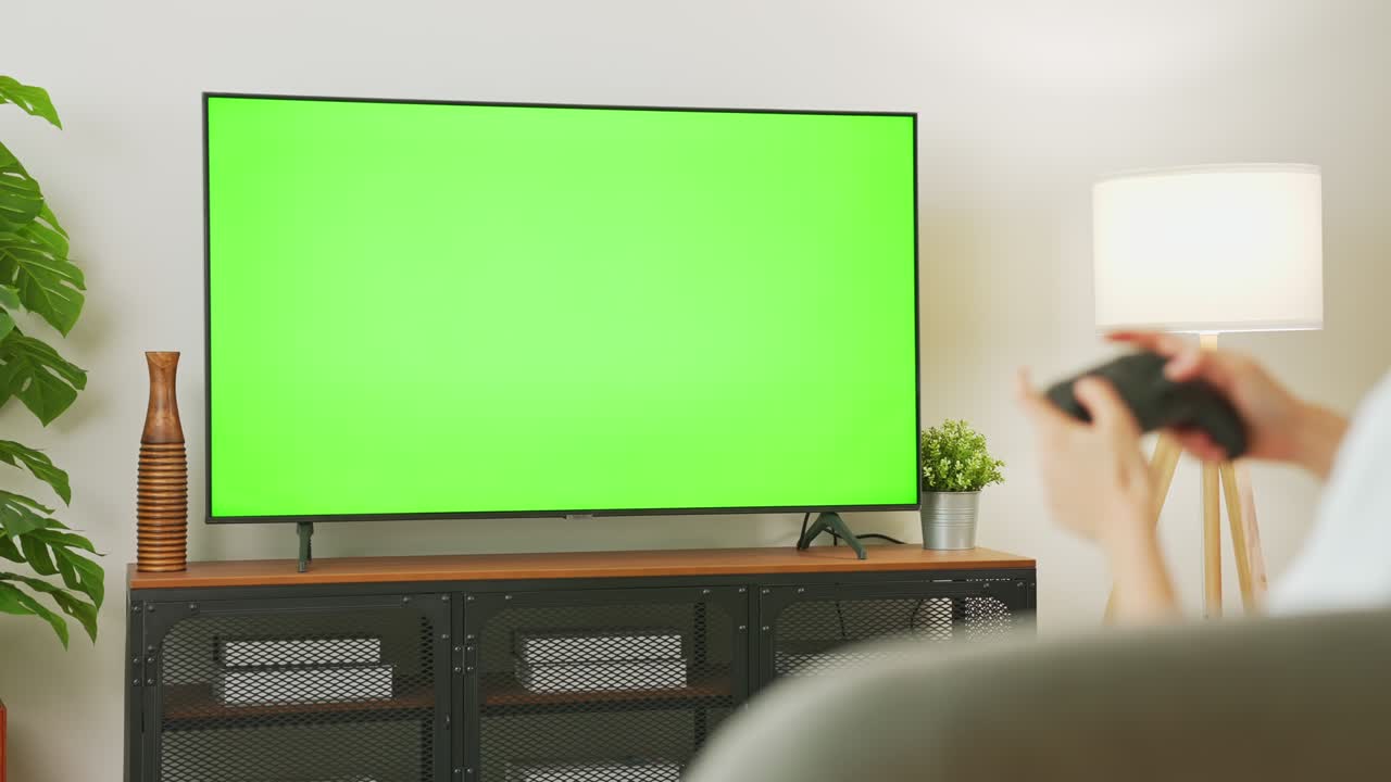 TV Green Screen in living room with tree and lamps. chroma key screen for advertising.