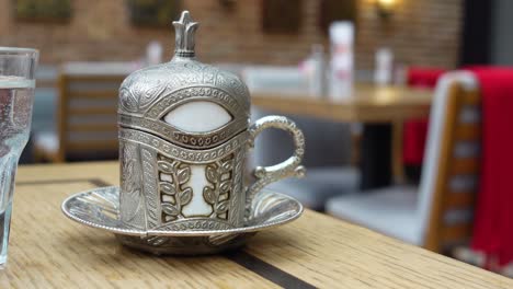 a traditional turkish coffee cup on a wooden table