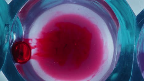blood droplet duffusing in transparent liquid during chemical experiment