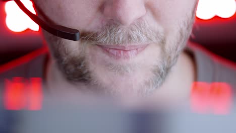 colourful lights: closeup lower face of man in telephone conversation