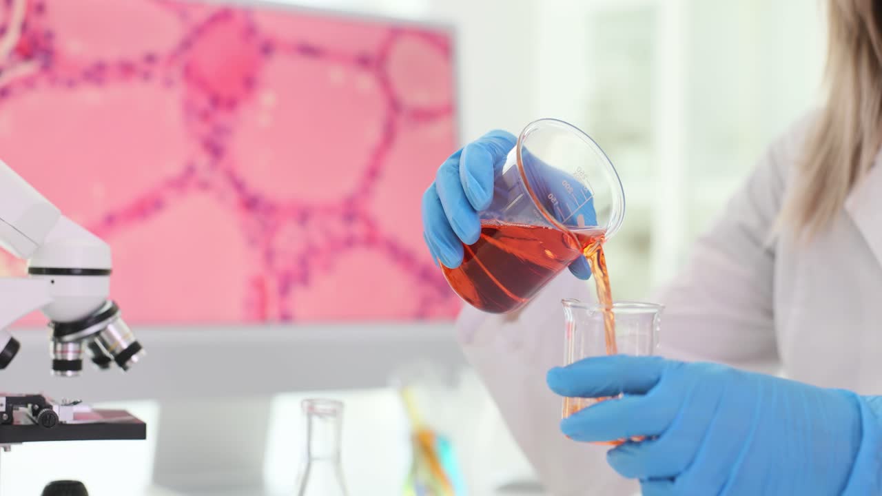 Scientist pouring liquid in laboratory