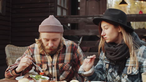 couple enjoying bbq meal outdoors