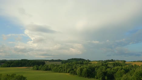 revealing aerial footage of countryside sunset view with puffy clouds