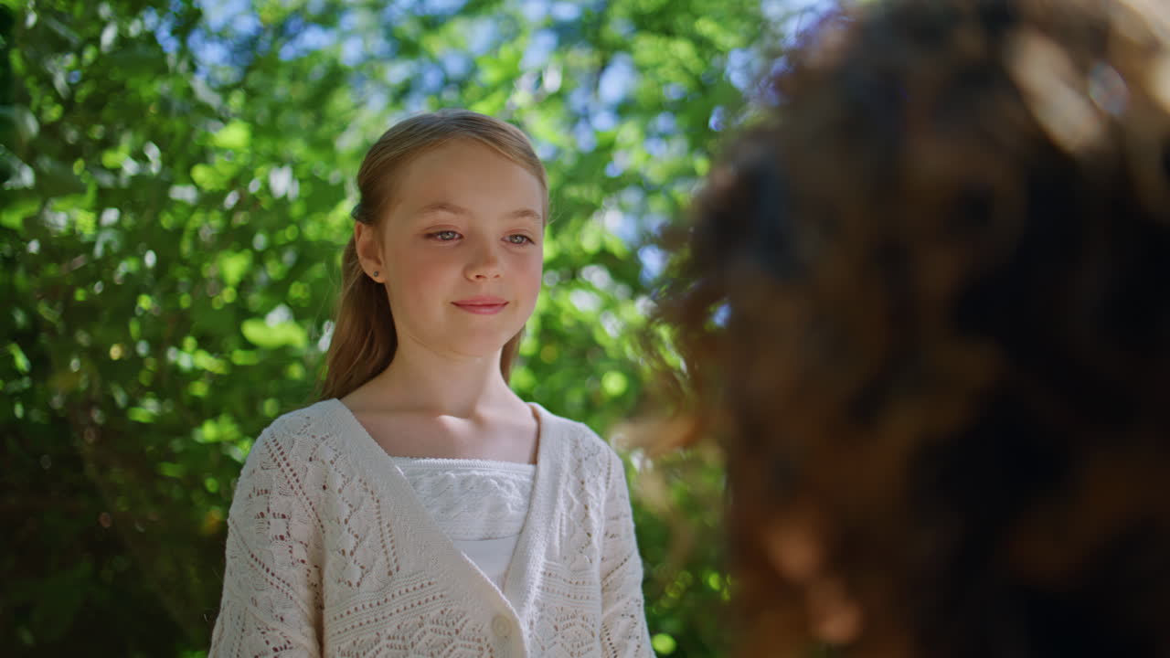 Small girl walking park looking unknown mother closeup. Kid communicating mom