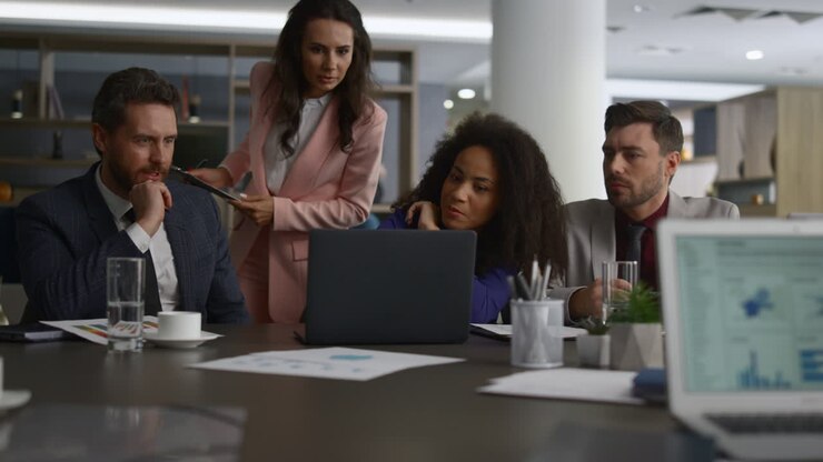Smiling coworkers chatting in workplace