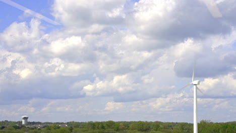 rapidly moving windmill near water tower