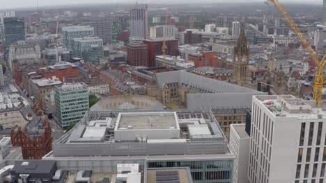 drone shot pulling up from buildings in manchester city centre