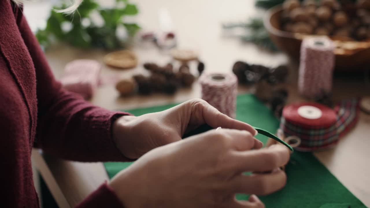 Close up of woman's hands preparing Christmas decoration
