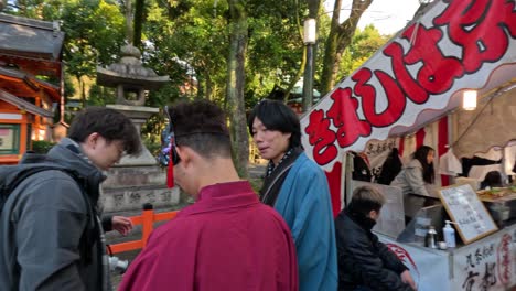 crowd observes a festive procession in a shrine