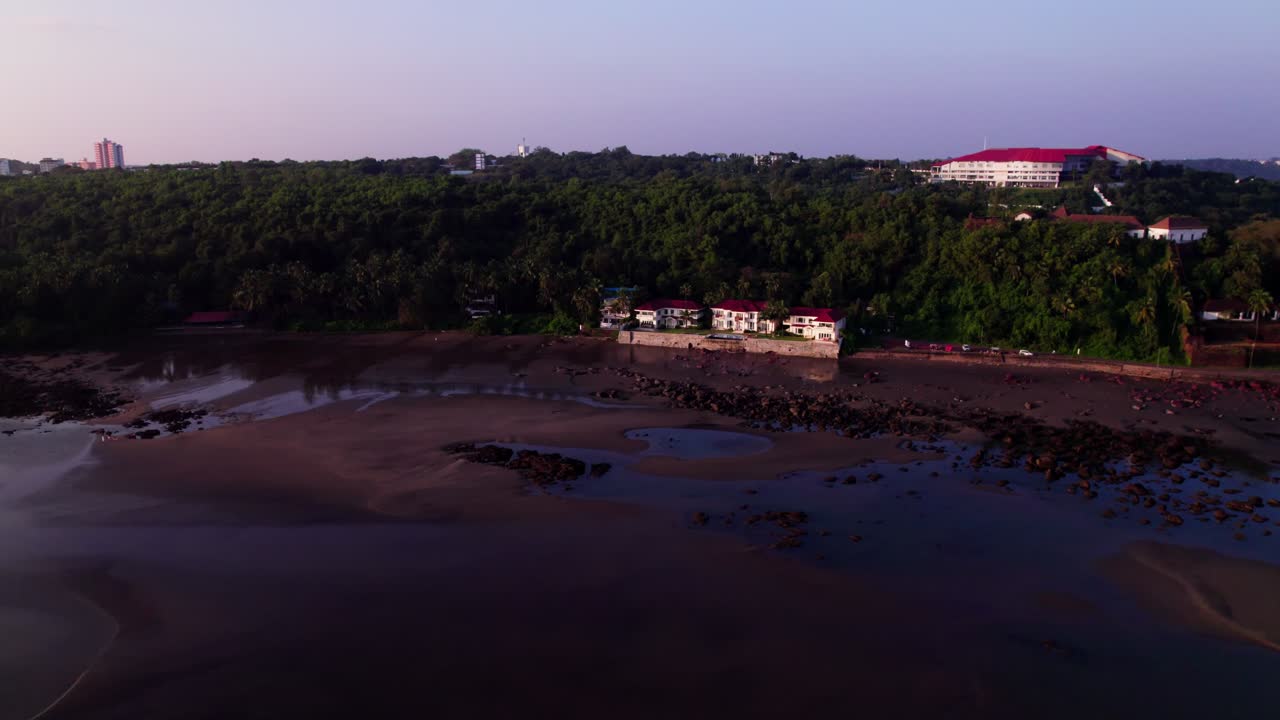 beach side mansion with forest and Naval War College at Quegdevelim Beach, reis magos, goa, india. evening time, push in shot, drone shot, 4k