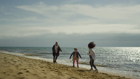 people jumping sea beach. playful family enjoy happy holiday at seaside nature.