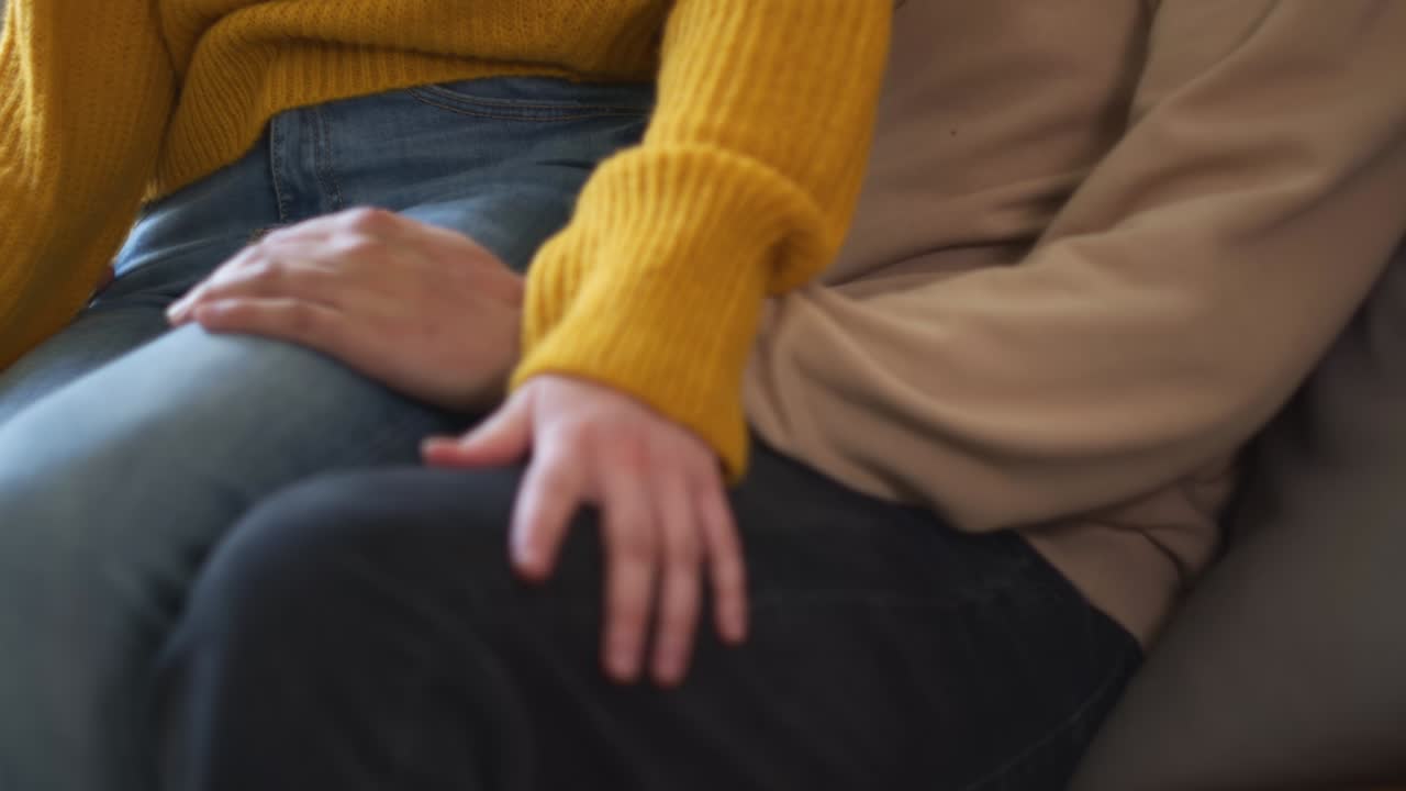 Woman Sits On The Lap Of Her Boyfriend. - closeup shot
